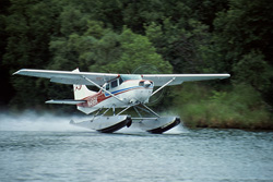A majestic bush plane takes off into the vast Alaskan wilderness