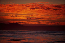 Romantic colors in the evening sky over the ocean in front of Dyer Island