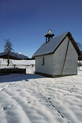 Romantic snow-covered chapel in Bavaria in winter