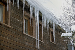 Fascinating icicles on the roof on a clear winter day