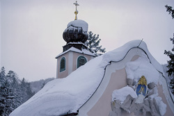 Picturesque snow-covered mountain chapel in the Bavarian Alps for winter themes