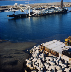 A 12 meter concrete block is finished at North Headland in Richards Bay Harbour with a cutter suction dredger in the background