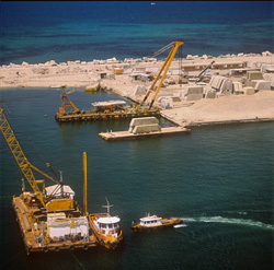 Elaborate preparation of a concrete block foundation using a crane barge in Ras el Tin Harbor, Alexandria, Egypt